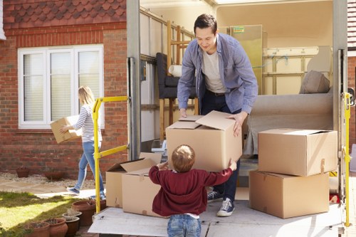 A moving team organising boxes and furniture for transport in Barnes