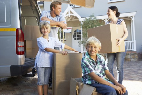 Professional movers carrying furniture through a Barnes home during relocation