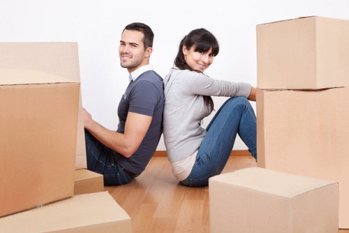 Two movers handling furniture during a relocation