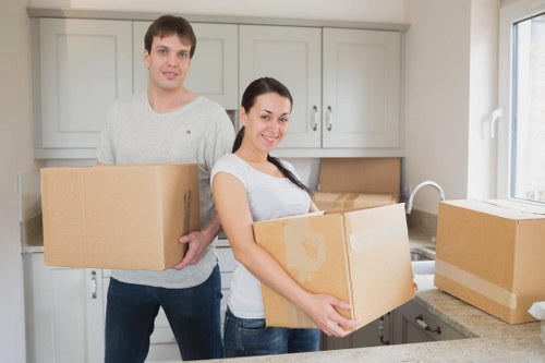 Professional movers loading household items into a removals van